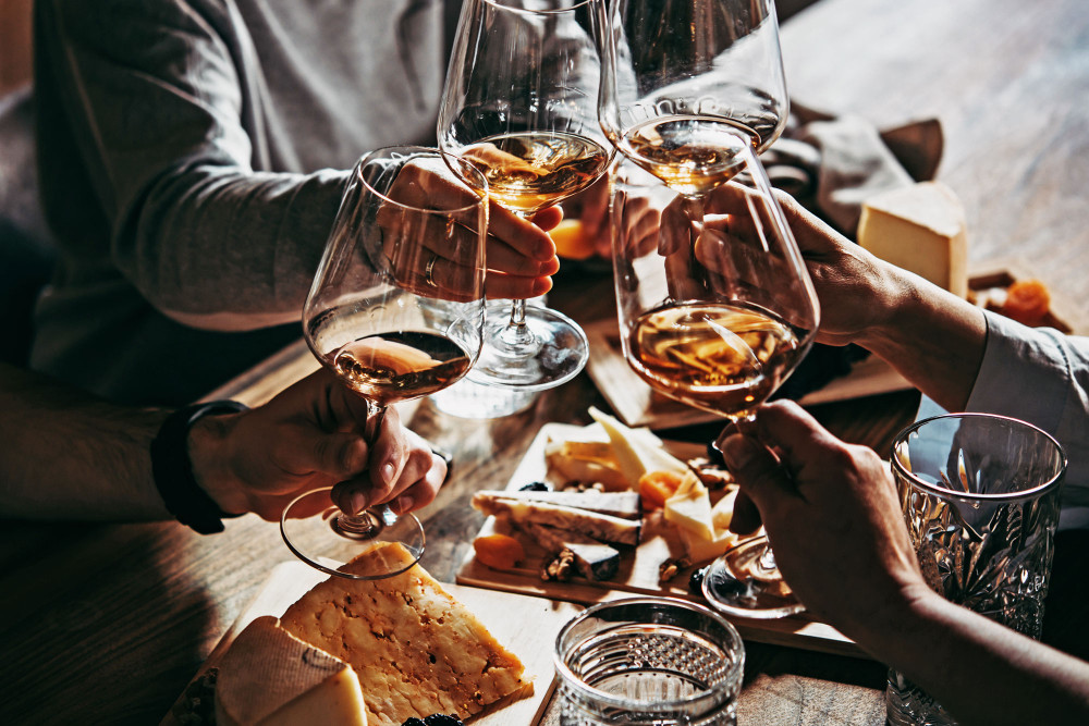 toasting with glasses of orange wine